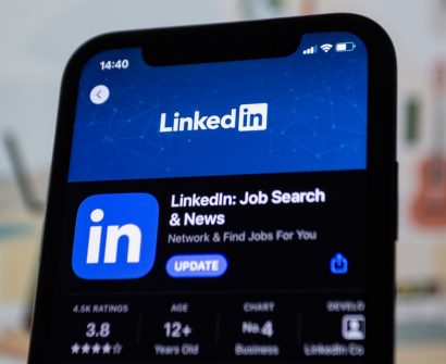 the linkedin logo is displayed on a smartphone